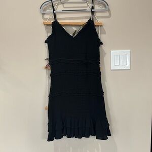 Form fittingg with ruffles, a little black dresss for any activity